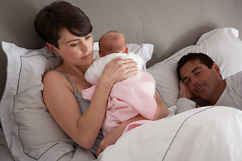 Couple in bed with baby
